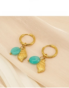 Detailed shot of titanium steel hoop earrings with shell pendant and turquoise stone