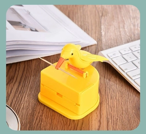 Detailed view of creative bird-shaped toothpick dispenser on wooden desk with domestic scene