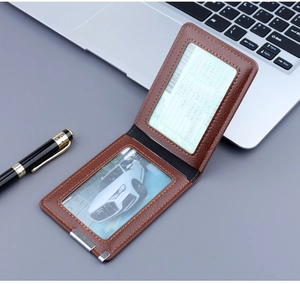 Detail view of brown lychee leather card holder with dual transparent interior slots