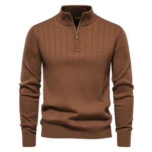 Detailed view of brown half-zip sweater showing vertical knit texture and metal logo detail