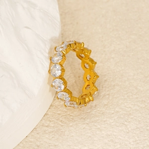 Macro view of 18k gold plated eternity ring with zircon stones on stone background