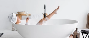 Modern white microfiber hair towel wrap shown in a relaxing lifestyle bathroom setting