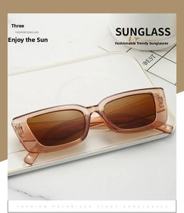 Flat lay of retro rectangle sunglasses in tawny brown on a white display tray