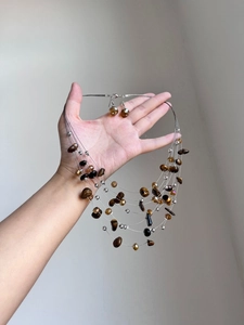 Detailed view of beaded tiger eye necklace and matching teardrop earrings set