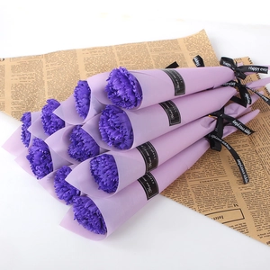Close-up of 12 purple soap carnation flowers wrapped in paper with Happy Everyday ribbon