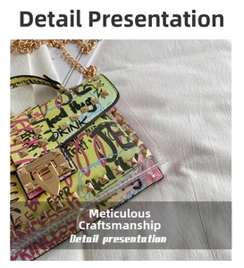 Detail of yellow graffiti jelly bag featuring golden pyramid studs and metal lock