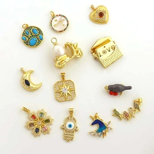Detailed close-up of mixed copper pendants with zircon inlay and colorful enamel charms