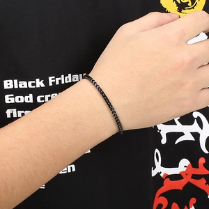 Close-up of black stainless steel square keel chain bracelet on male model wrist