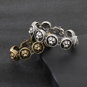 Detail of vintage tiger head bracelets in antique gold and silver finishes for men
