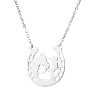 Macro detail of silver horseshoe necklace pendant with cowboy and horse silhouette