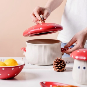 Macro shot of squirrel handle on red mushroom ceramic bowl lid with polka dots