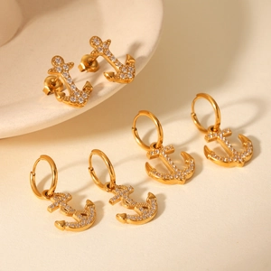 Detail of 18K gold stainless steel anchor earrings with sparkling white diamonds