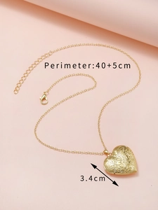Detailed view of golden heart locket necklace with perimeter 40+5cm and 3.4cm pendant