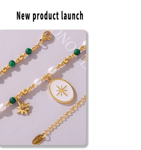 Detail of stainless steel bead necklace with green malachite, pearls, and star pendant