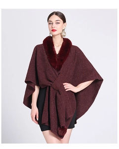 Detail of burgundy knitted poncho featuring a luxurious faux rabbit fur collar for women