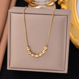 Double-layered gold titanium steel necklace featuring a curved seven-bead arc pendant