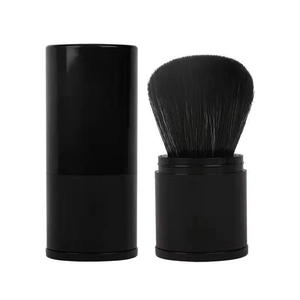 Detail view of portable retractable makeup brush with black soft bristles and protective lid