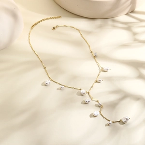 Detail of baroque pearl necklace with golden chain and adjustable lobster clasp closure