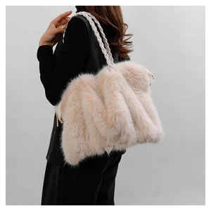 Detail of soft beige faux fur tote bag featuring unique white braided rope shoulder straps