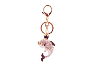 Close-up of golden crown dolphin keychain with purple enamel and sparkling rhinestones
