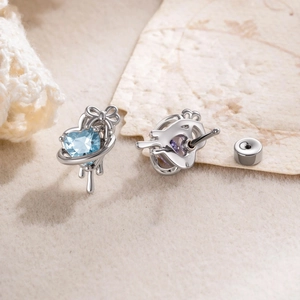 Lava bow heart earring with blue zircon and 925 silver stud in a detailed front-back view