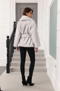 Detail of light grey faux fur coat showing back cut and plush texture with belt