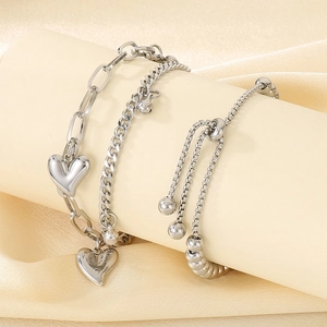 Detail of silver heart pendants and layered steel chains with adjustable slider clasp