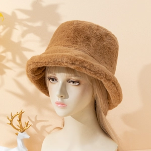 Close-up of thick faux fur bucket hat in caramel brown with soft plush texture for winter