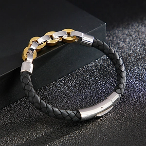 Men's black braided bracelet with gold and silver stainless steel rings and polished clasp