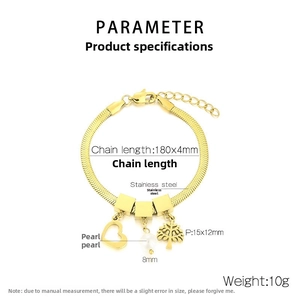 Detailed view of golden stainless steel heart and tree charms with a pearl and snake chain