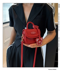 Red mini PU leather crossbody bag with teddy bear charm and stylish shoulder strap