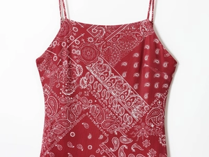 Detailed view of red paisley print fabric and waist ties on a casual summer dress