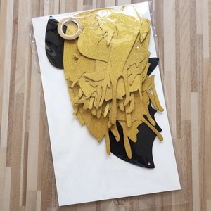 DIY Halloween decoration set with gold glitter and black bat shapes on wooden background