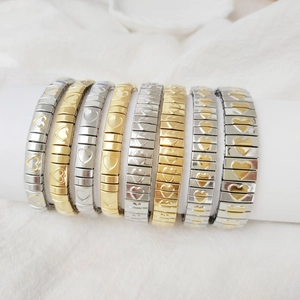 Detail view of Italian charm stretch bracelets with gold and silver heart charms on a stand