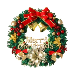 Close-up of a Christmas wreath with gold bells, red bow, and Merry Christmas sign