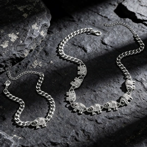 Detailed close-up of elephant pendant necklace on dark rock with natural lighting