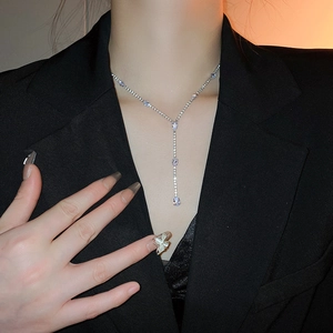 Luxurious silver Y-shaped drop tassel necklace with zircon stones on a female model