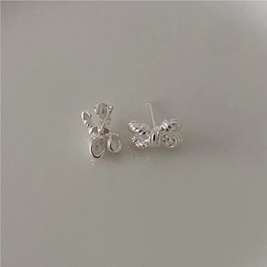 Detailed close-up of 925 sterling silver bow knot stud earrings in a minimalist style