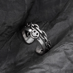 Close-up of vintage silver smile face ring with chain link and adjustable open band