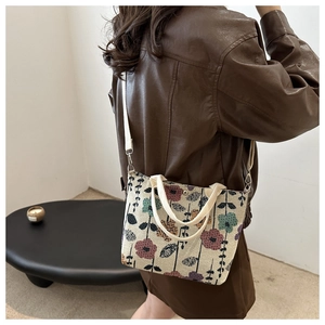 Floral canvas tote bag with magnetic closure shown on shoulder in a lifestyle setting