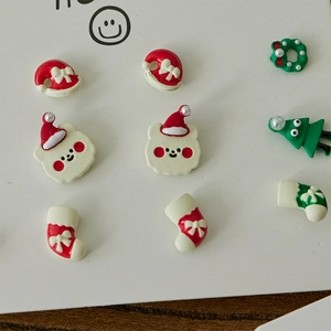 Christmas stud earrings set with festive tree, bear, and boots on a display card