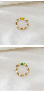 Detail view of stretch bead rings with freshwater pearls and colored accent stones