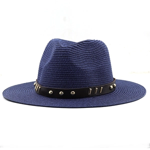 Detail of navy blue straw fedora with black leather band and gold stud embellishments