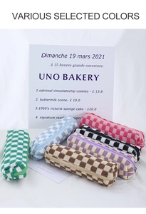 Detail of colorful checkered knitted pencil cases with secure metal zipper closure