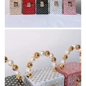 Detailed view of luxury acrylic evening clutch bags with pearl handle and rhinestone finish