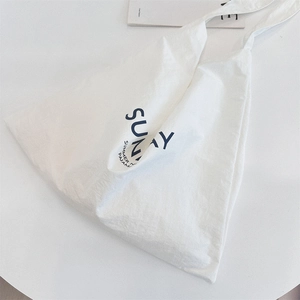 Macro detail of high-quality white canvas tote bag with black SUNNY SUMMER PAJAMAS print