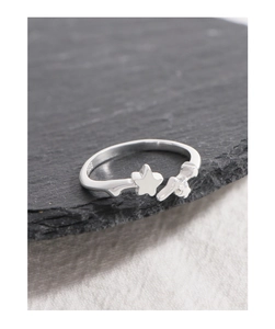 Close-up of S925 sterling silver star ring on elegant stone and fabric texture