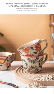 Close-up of ceramic mugs with hand-painted sunflower and floral patterns in a rustic style