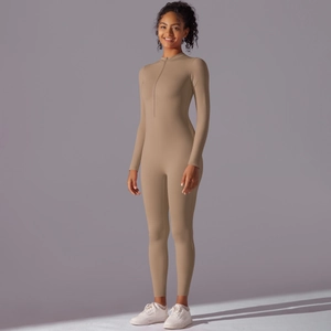 Detail of camel long sleeve zip-up bodysuit featuring a stand collar and athletic fabric
