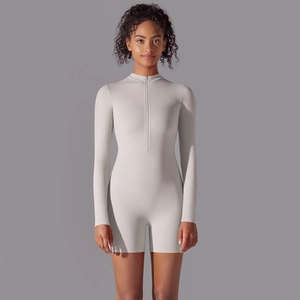 Close-up of light gray athletic romper featuring a zipper collar and long sleeves